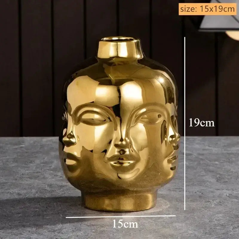 Golden handmade ceramic face vase shaped like a serene multi-faced buddha head for home decor art vase sculpture