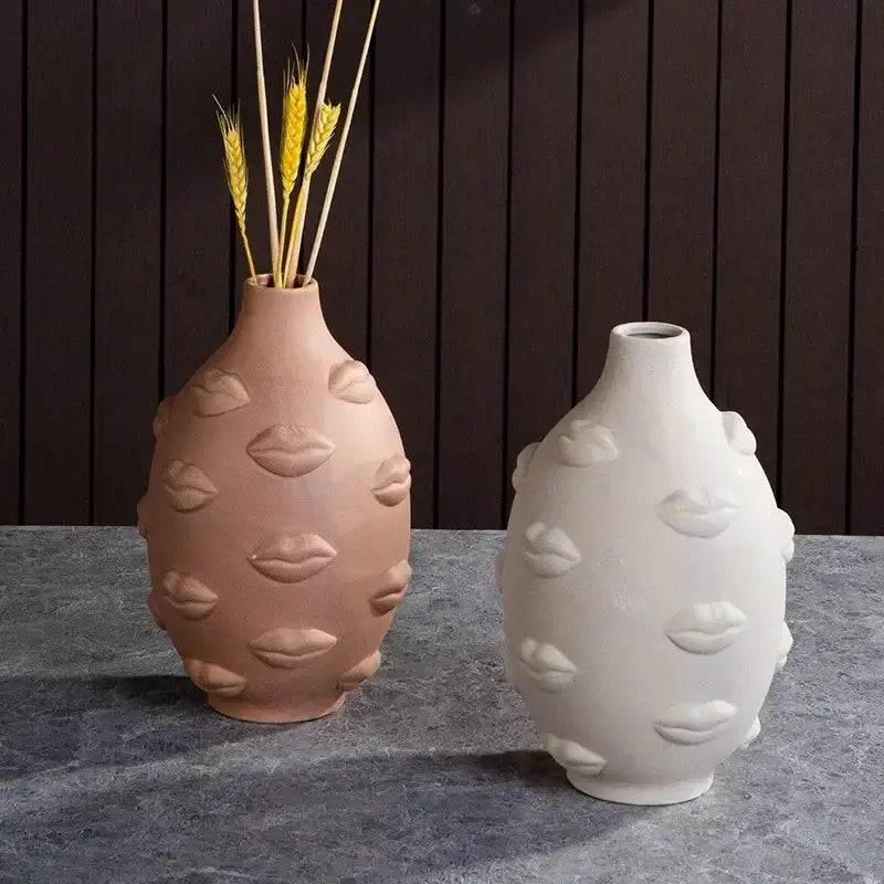 Twin handmade ceramic face vases in terracotta and matte white with raised lip motifs for home decor and art vase sculpture