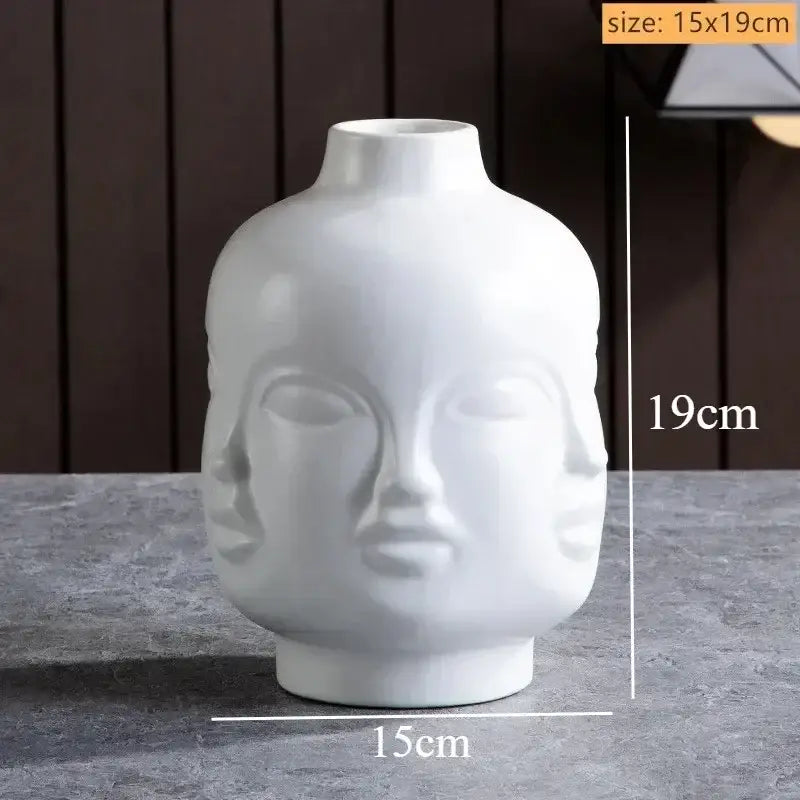 White ceramic handmade ceramic face vase shaped like a serene buddha head with three faces for home decor