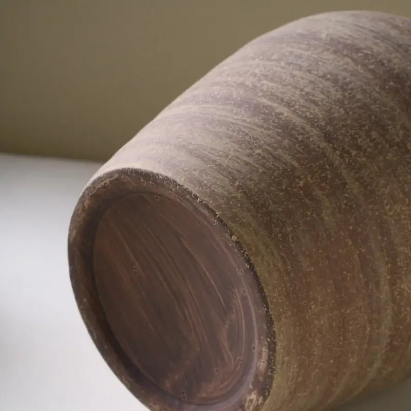 DecorBites™ handmade ceramic vase in rustic brown with textured surface and wood grain base for home decoration