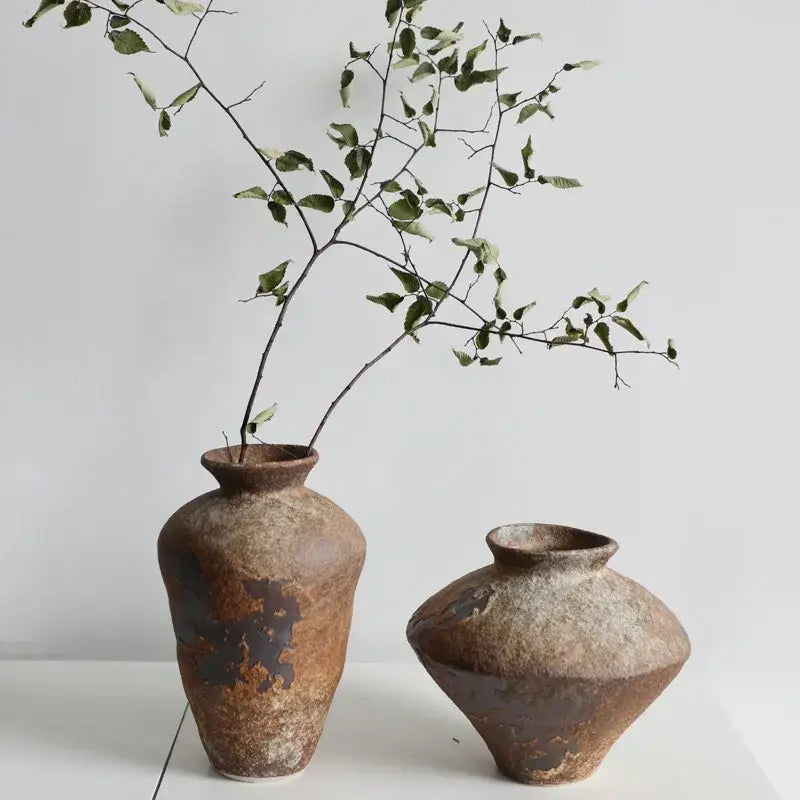 Two rustic brown handmade ceramic vases with earthy textured surfaces for zen flower arrangements by decorbites