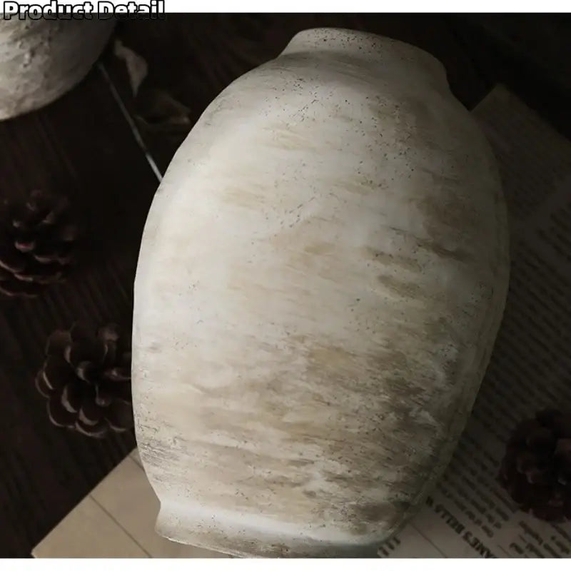 An off-white handmade ceramic vase with textured weathered surface and beige streaks from decorbites vintage style ceramic vases