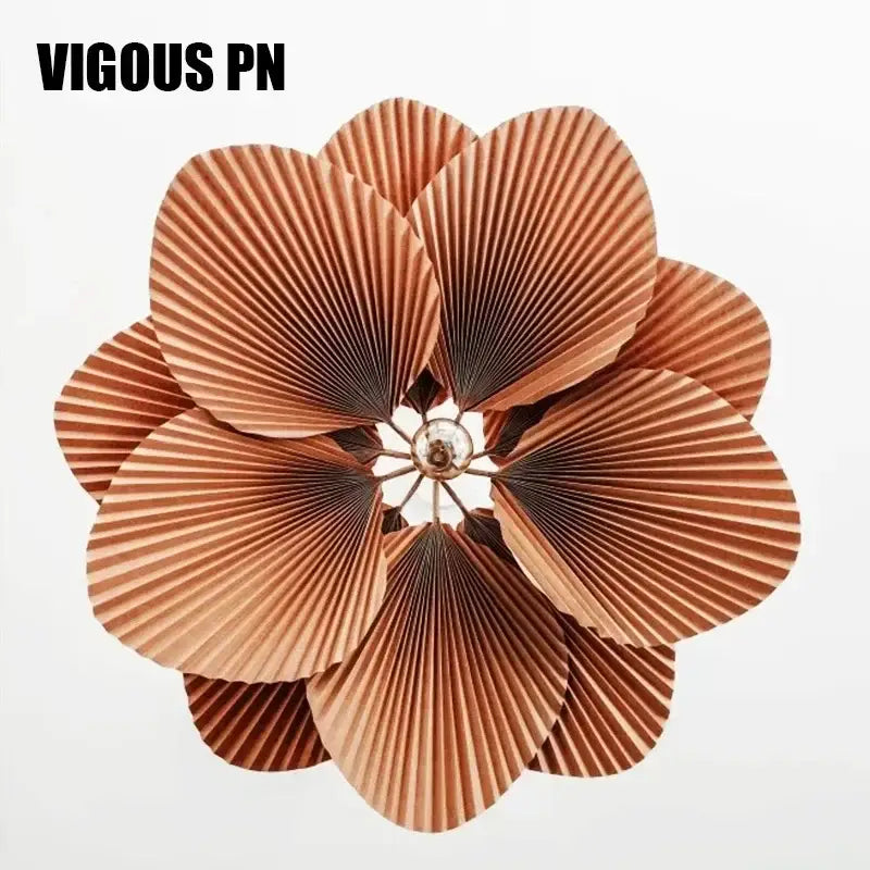 Decorbites handmade floral chandelier featuring copper-colored pleated paper flower with central metallic accent for dining room lighting