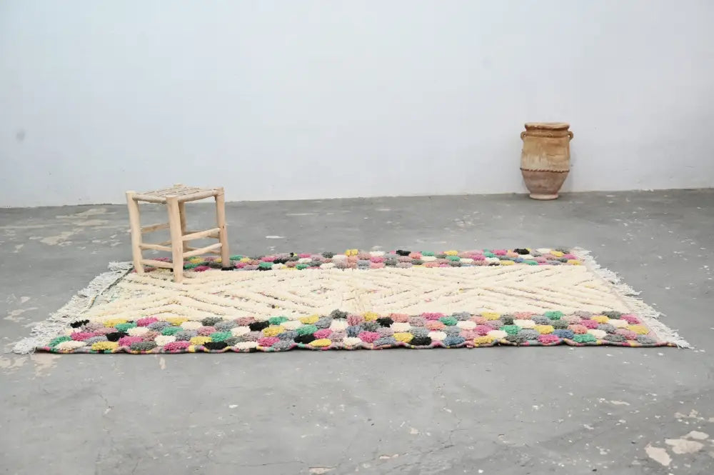 Colorful handmade Moroccan azilal rug 222x133 with cream central field and vibrant multicolored fringe by DecorBites