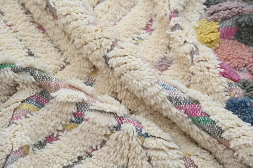 Cream-colored plush handwoven DecorBites™ azilal rug 222x133 with textured fringed surface and colorful geometric patterns