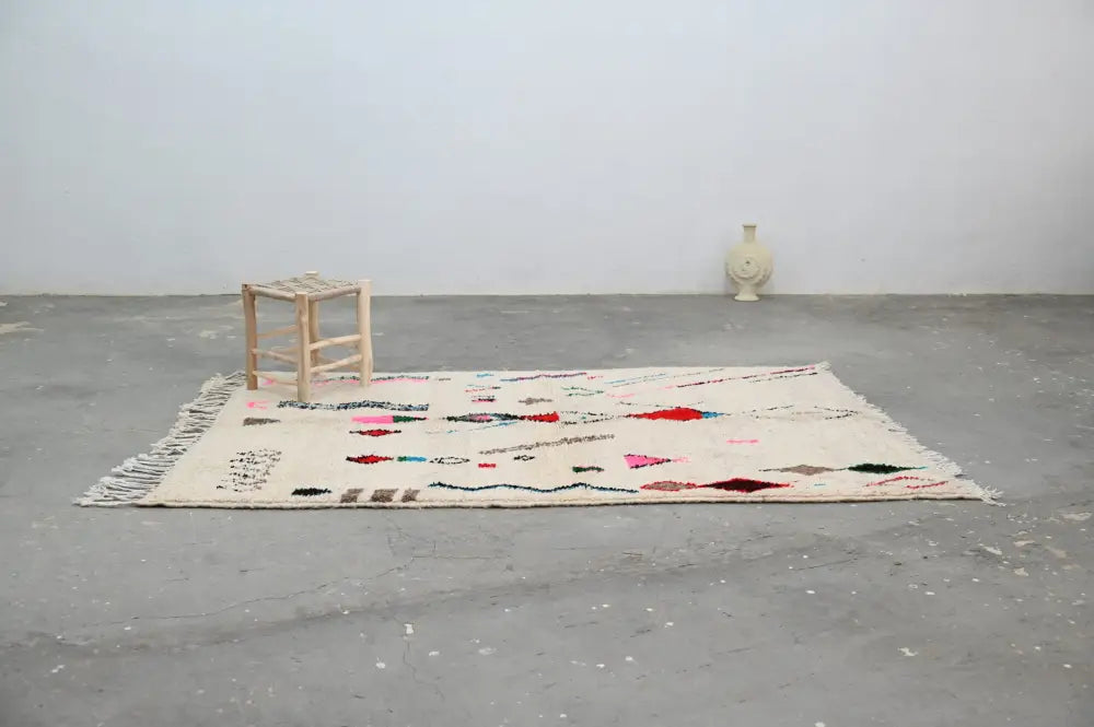 Beige moroccan handmade azilal rug with colorful geometric patterns fringed edges natural wool 223x157cm