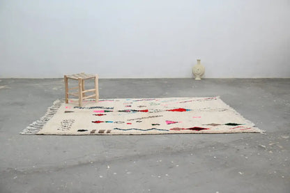 Beige moroccan handmade azilal rug with colorful geometric patterns fringed edges natural wool 223x157cm