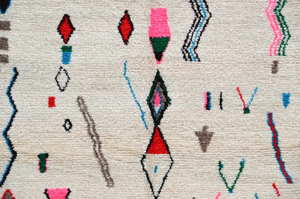 Beige moroccan handmade azilal rug in natural wool with vibrant geometric patterns in red pink green blue and black 223x157cm