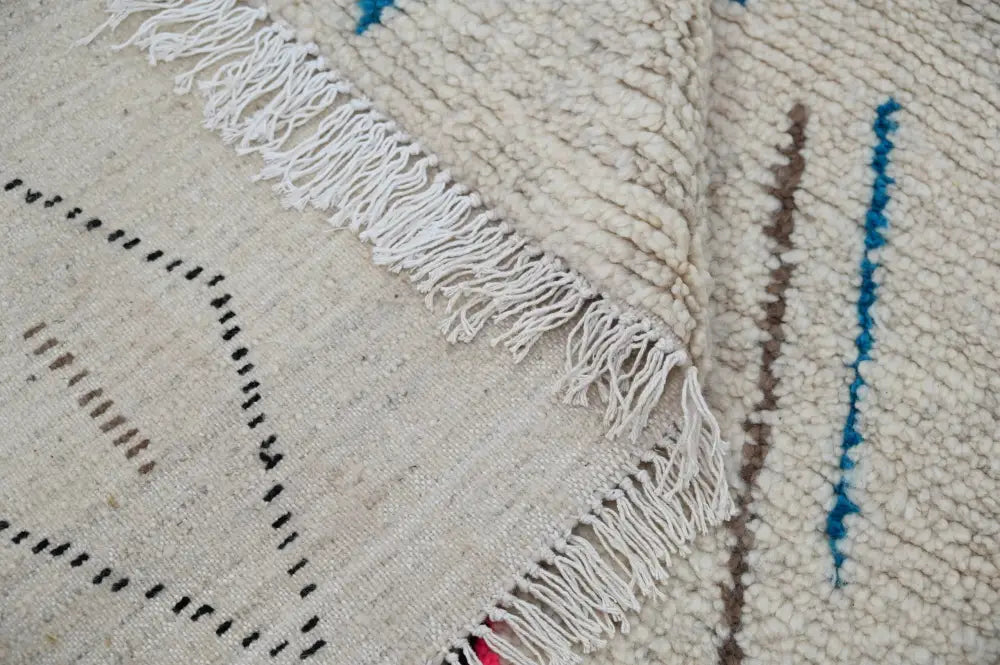 Cream-colored decorbites™ handmade moroccan azilal rug with blue brown black geometric patterns in natural wool 223x157cm
