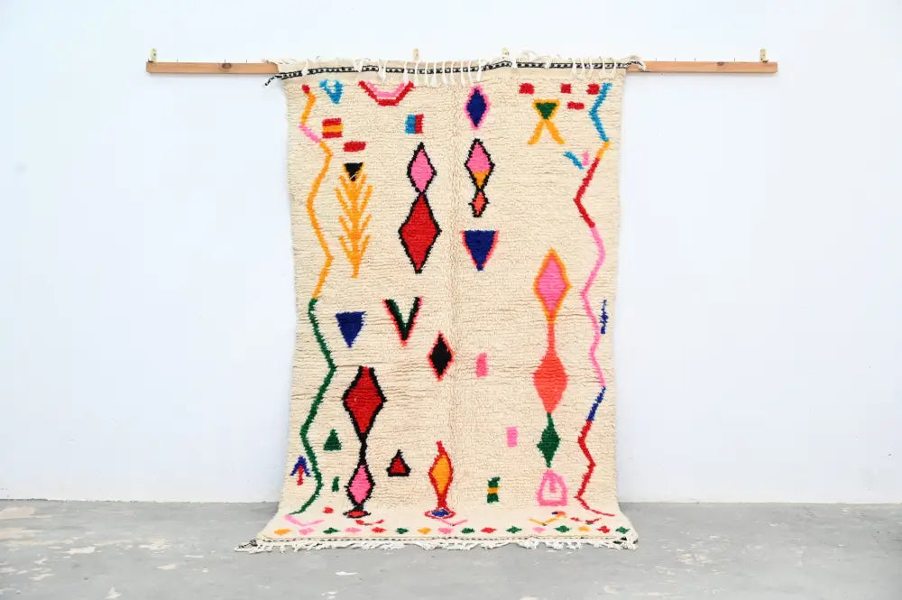 Beige moroccan handmade azilal rug with vibrant geometric patterns in natural wool by DecorBites 231x131cm