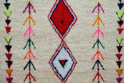 DecorBites™ handmade moroccan azilal rug with vibrant red and white diamonds and colorful geometric motifs on cream base