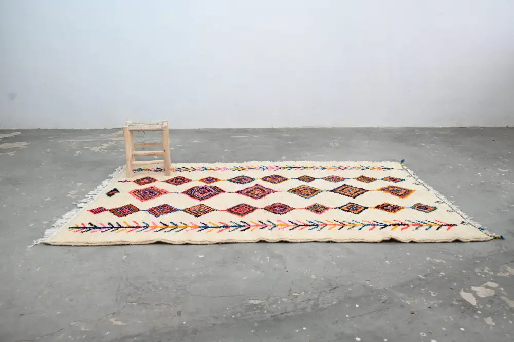 Cream-colored decorbites™ handmade moroccan azilal rug 236x155cm with intricate red purple and multicolored geometric patterns