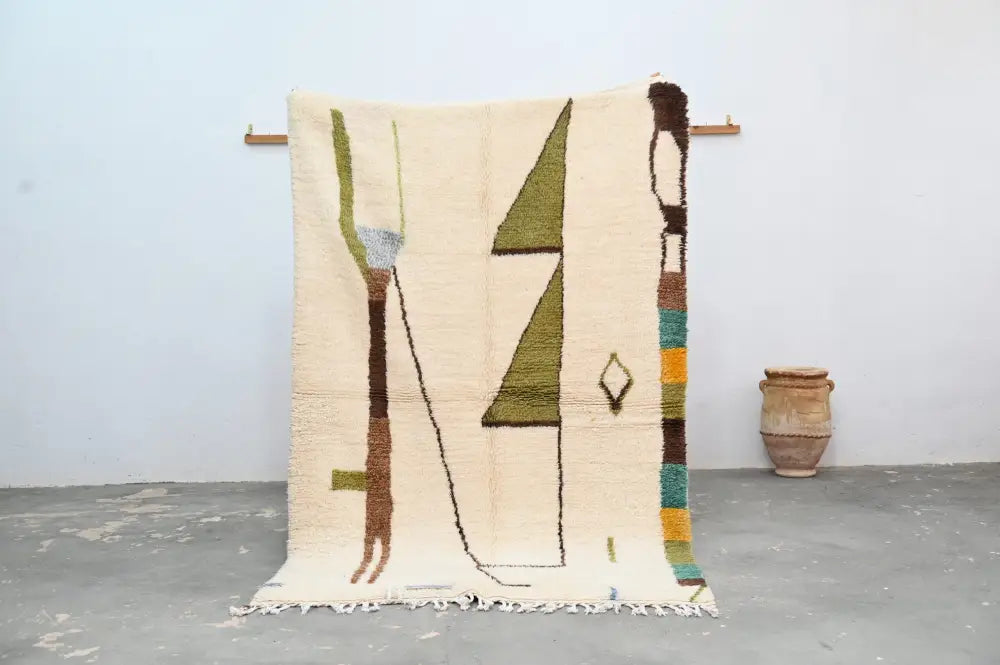 Cream-colored handmade traditional azilal rug with olive green brown and teal geometric patterns moroccan handmade