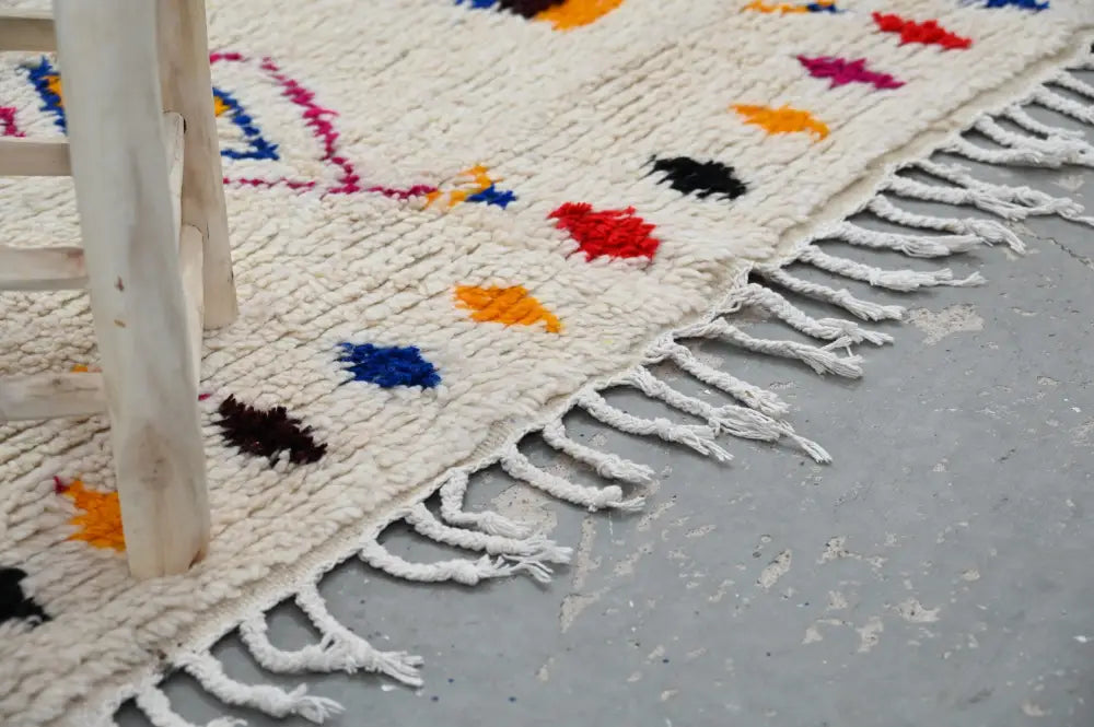 Cream-colored decorbites™ handmade azilal rug 240x132cm with colorful geometric patterns and white fringe