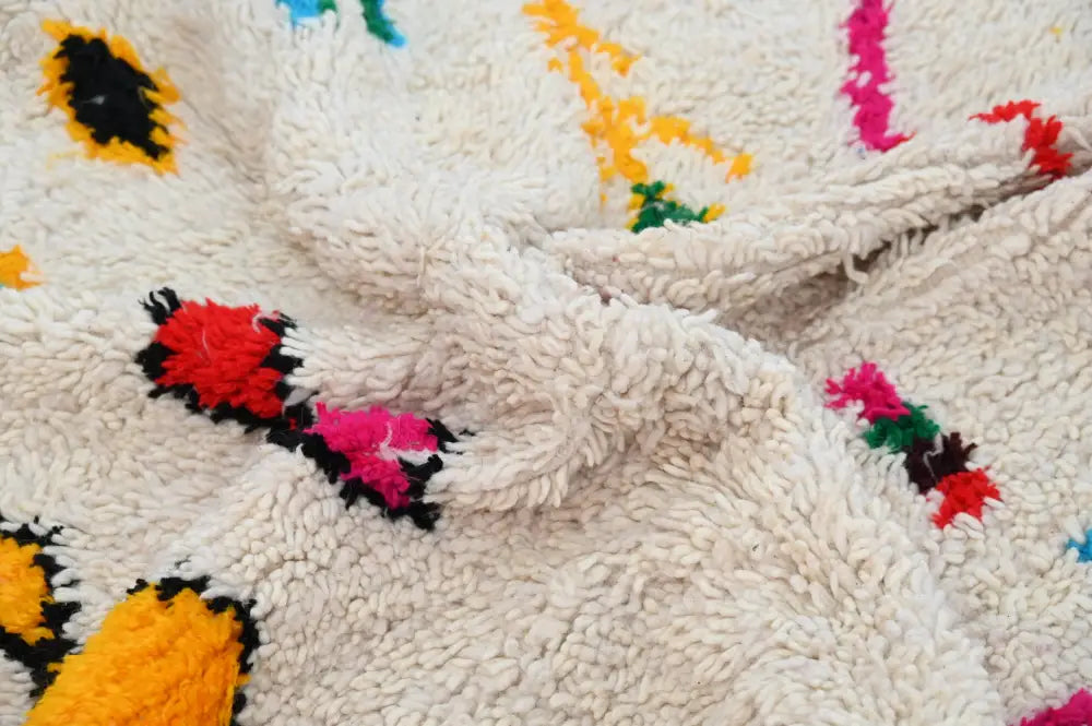 Cream-colored plush wool azilal rug 240x132cm with vibrant red pink yellow black and green geometric patterns by decorbites