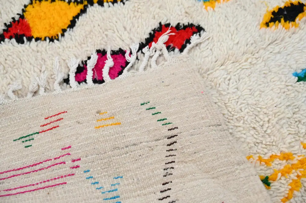 Cream-colored decorbites™ handmade moroccan azilal rug 240x132cm with vibrant hand-knotted geometric patterns