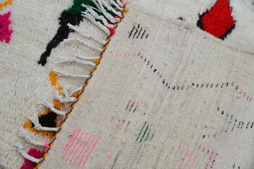 Handwoven decorbites™ handmade traditional azilal rug with cream base and bold geometric patterns with white fringe