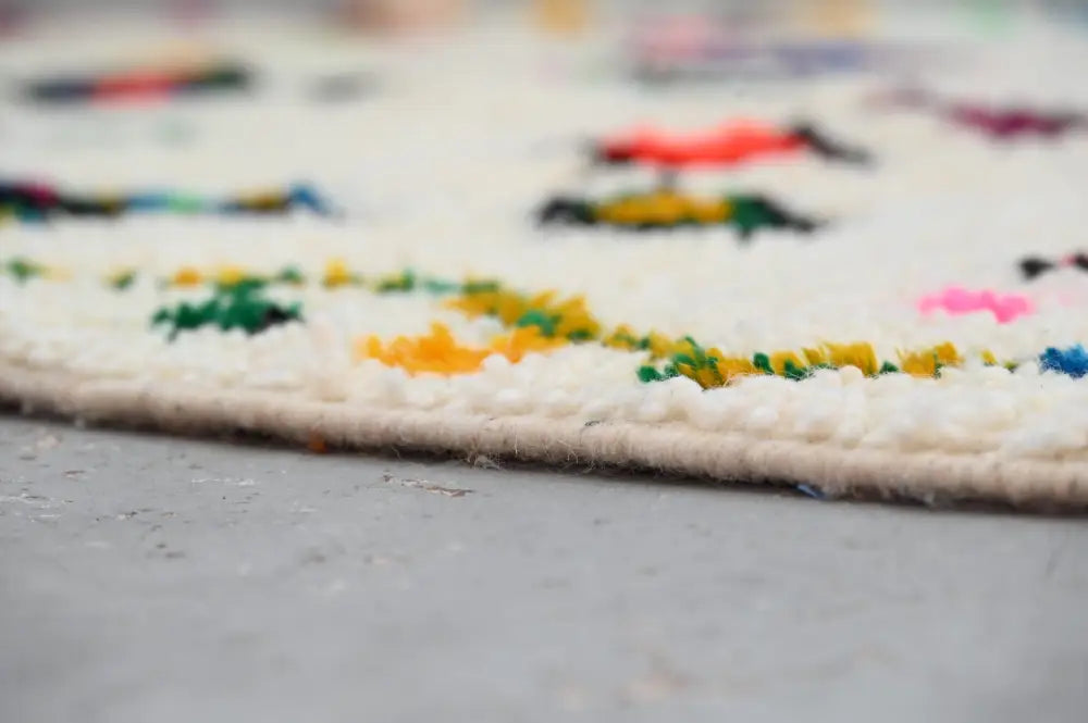Cream-colored decorbites™ handmade moroccan azilal rug 240x144cm with vibrant multicolored geometric patterns