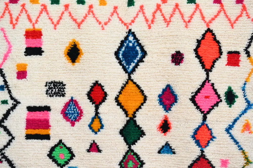 Vibrant geometric-patterned DecorBites™ Handmade Moroccan azilal rug 240x144cm with multicolored diamond shapes on cream base
