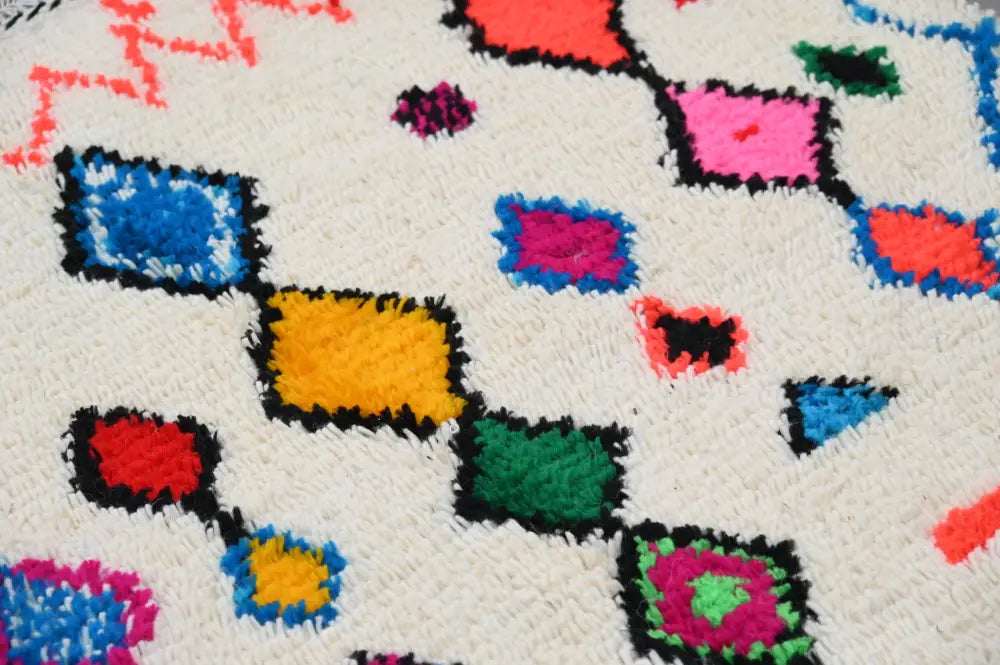 DecorBites™ handmade Moroccan azilal rug 240x144cm with vibrant geometric patterns on a white base