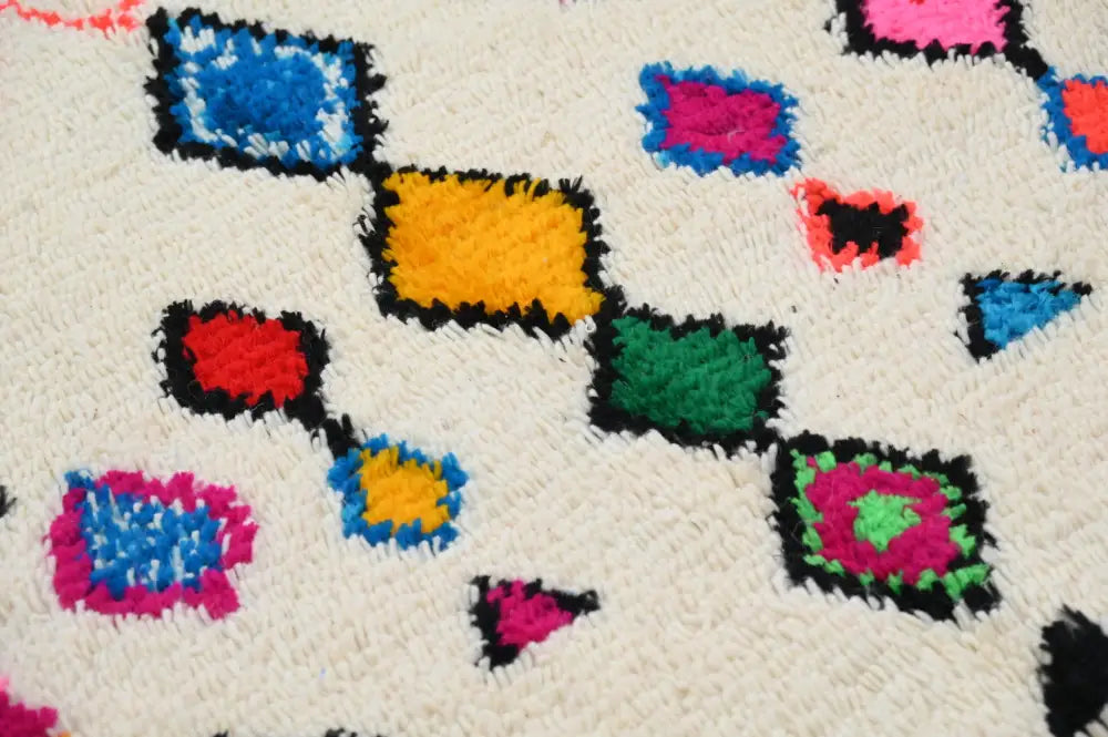 A vibrant handmade DecorBites™ Moroccan azilal rug 240x144cm with cream base and bold multicolor geometric patterns