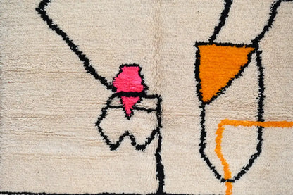 Beige wool moroccan azilal rug with bold black outlines and vibrant pink and orange geometric shapes 240x152 cm decorbites