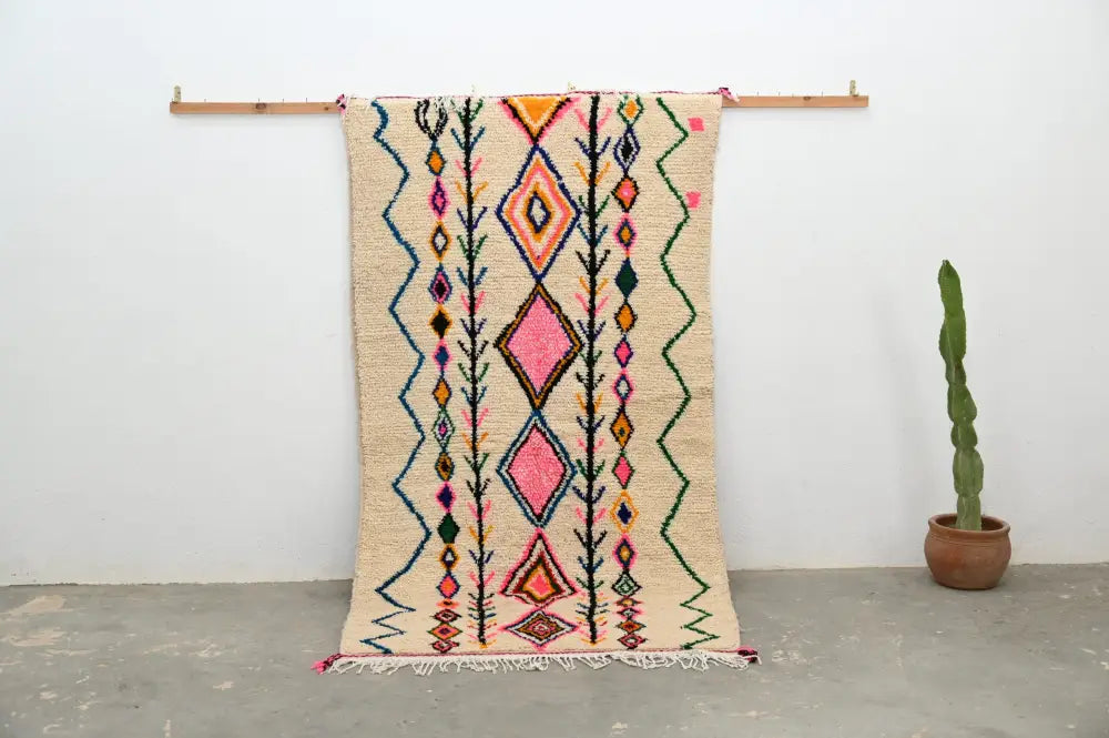 Beige handmade moroccan azilal rug with vibrant pink orange green and blue geometric patterns by DecorBites™ 243x131 cm