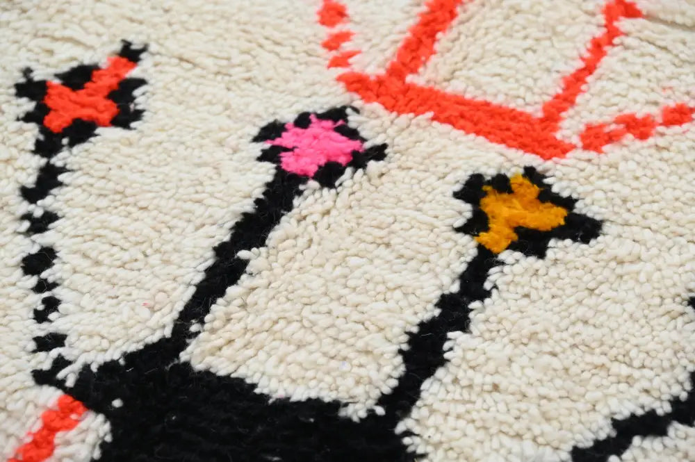 Cream-colored wool handmade moroccan azilal rug with bold black orange and pink geometric patterns 245x141cm