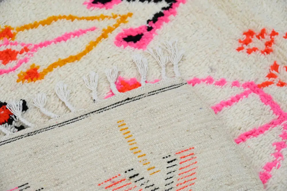 Vibrant pink orange and black geometric-patterned cream wool handmade moroccan azilal rug with white fringe 245x141cm