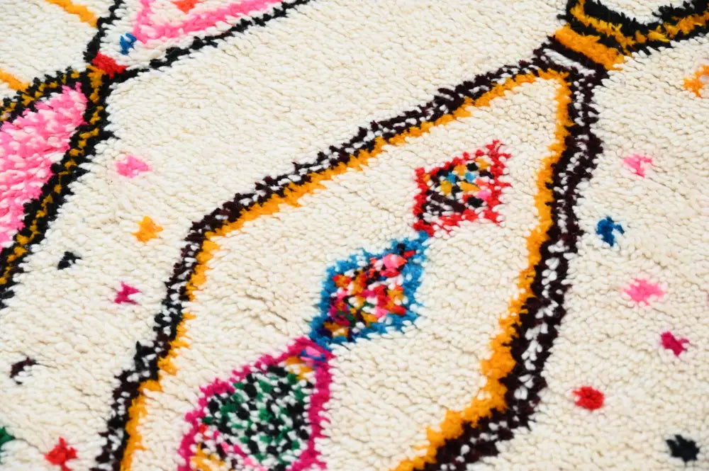 Cream-colored decorbites handmade moroccan azilal rug with vibrant pink orange black geometric patterns 245x146 cm