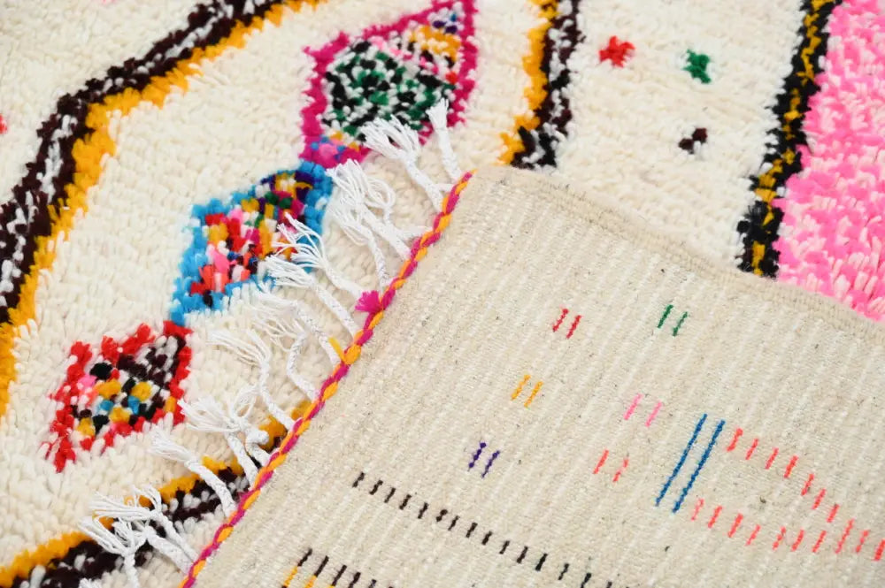 DecorBites™ handmade moroccan azilal rug with cream base and vibrant geometric pink blue yellow green and black patterns