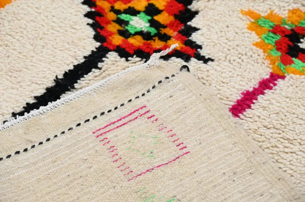 Cream-colored handmade moroccan azilal rug with vibrant orange red green and black geometric patterns 246x146 cm