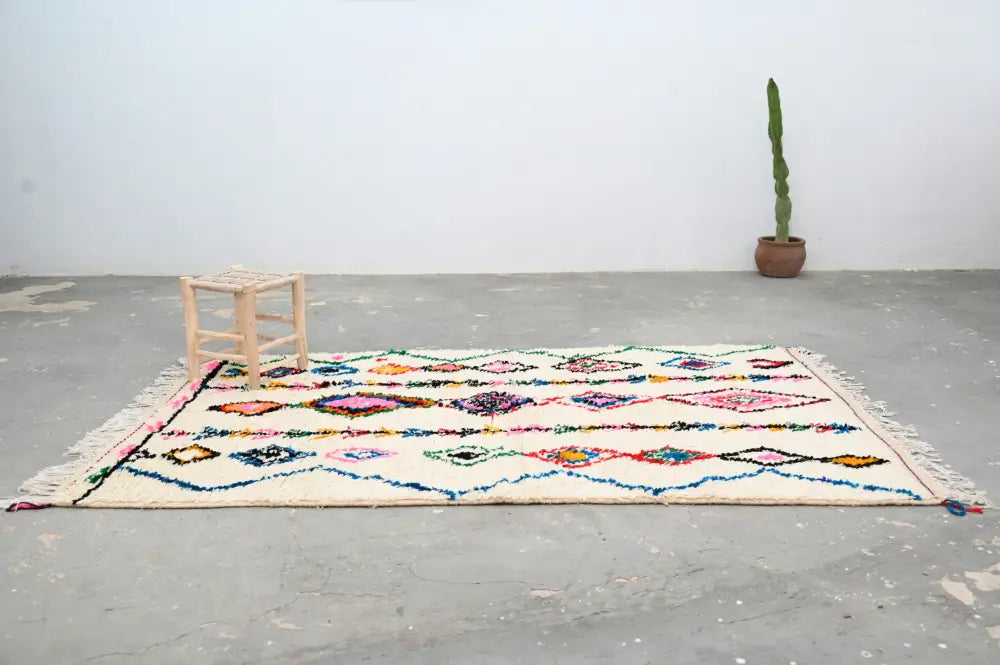 DecorBites™ handmade moroccan azilal rug with cream base and vibrant geometric patterns in natural wool 246x148 cm