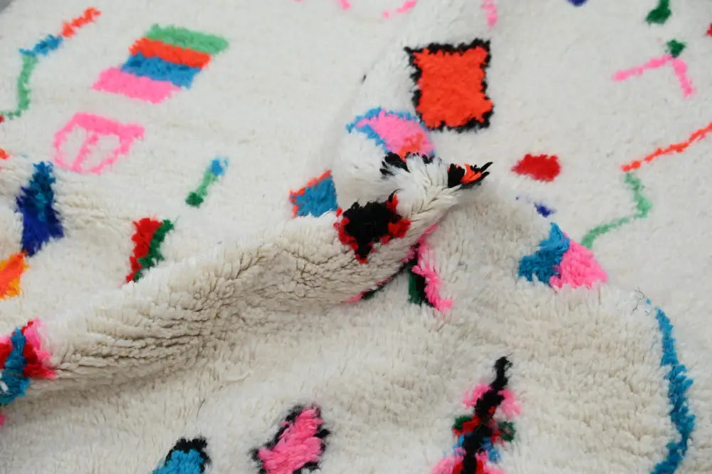 Decorbites™ handmade moroccan azilal rug with fluffy white texture and vibrant pink blue green red geometric patterns 247x141 cm