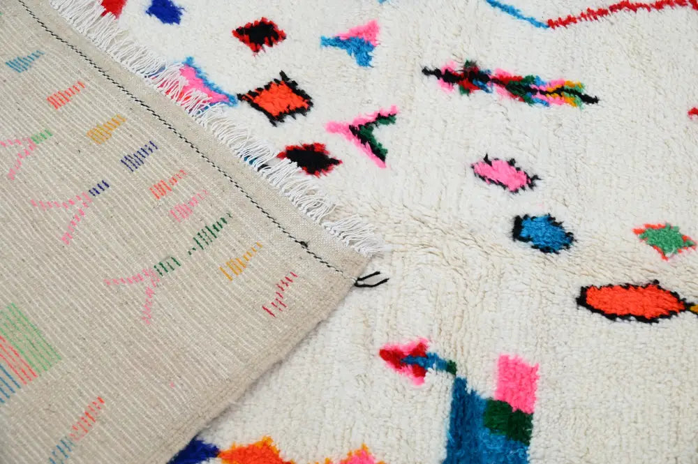 A vibrant handmade moroccan azilal rug with cream base and colorful geometric patterns 247x141 cm by decorbites