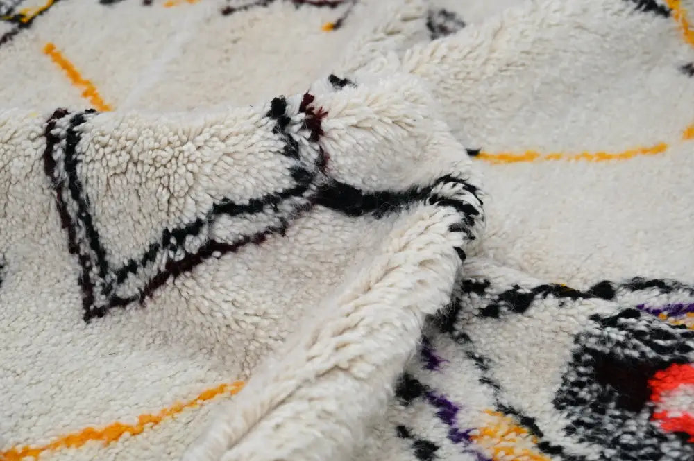 DecorBites™ handmade moroccan azilal rug with off-white plush texture and bold black orange purple red geometric patterns