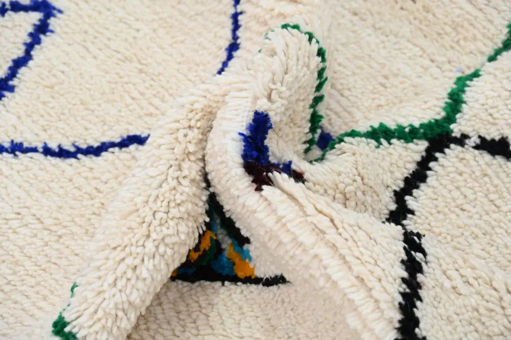 Cream-colored plush wool handmade moroccan azilal rug with bold blue green black and orange geometric patterns 250x141 cm
