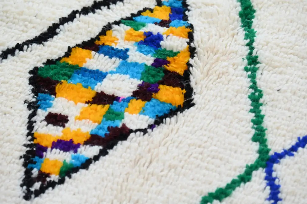 Decorbites™ handmade moroccan azilal rug with vibrant blue green yellow purple diamond pattern on soft white background