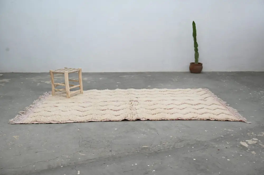 Cream-colored handmade traditional azilal rug with textured wavy pattern and fringed edges wool 250x143cm