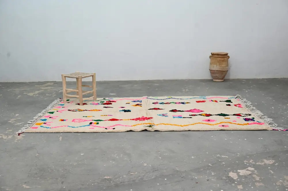 DecorBites™ handmade moroccan azilal rug 250x145 cm with cream base and colorful geometric patterns in pink yellow blue green red