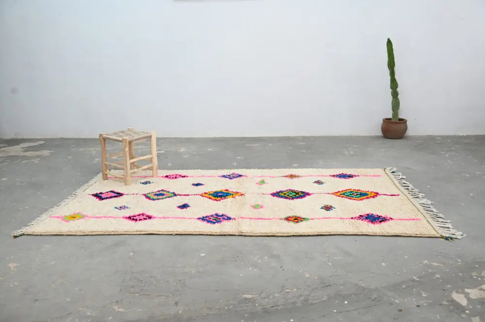 Beige handmade moroccan azilal rug with colorful geometric patterns and fringed edges, 250x148 cm by DecorBites