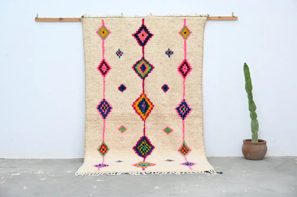 Beige handmade moroccan azilal rug with vibrant pink purple green and orange geometric patterns 250x148 cm decorbites