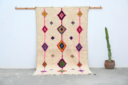 Beige handmade moroccan azilal rug with vibrant pink purple green and orange geometric patterns 250x148 cm decorbites