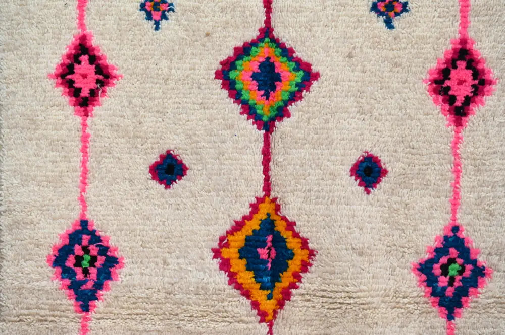 Beige wool decorbites handmade moroccan azilal rug with vibrant pink blue green and orange geometric patterns 250x148 cm