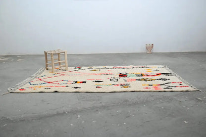 Beige wool DecorBites™ handmade moroccan azilal rug with colorful geometric patterns and fringed edges 250x154cm