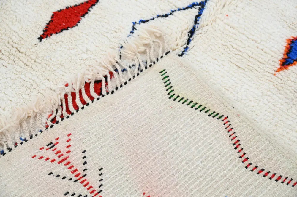 Cream-colored DecorBites™ handmade Moroccan Azilal rug with bold red blue and green geometric patterns 285x220 cm