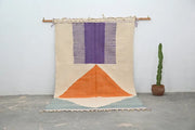 DecorBites™ handmade moroccan azilal rug with beige purple and orange geometric design in natural wool hanging on wooden rod