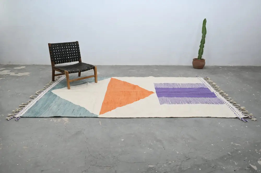 Decorbites™ handmade moroccan azilal rug with bold orange and purple geometric patterns on natural wool cream base