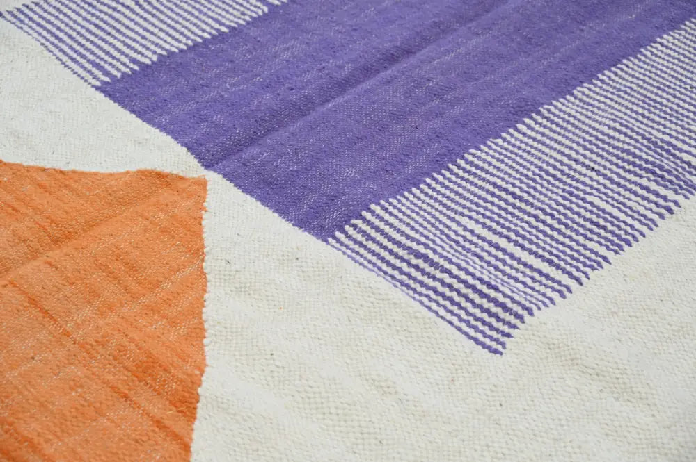 DecorBites™ handmade moroccan azilal rug in natural wool with bold purple and orange geometric blocks on cream background