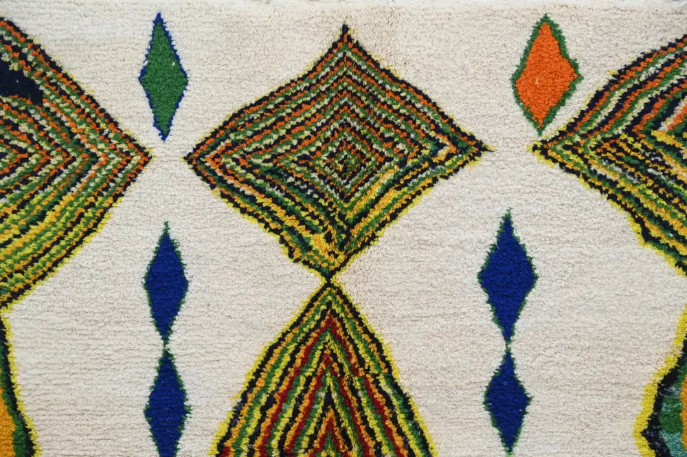 Handwoven cream azilal rug with bold green orange and blue geometric patterns from decorbites handmade moroccan azilal rug